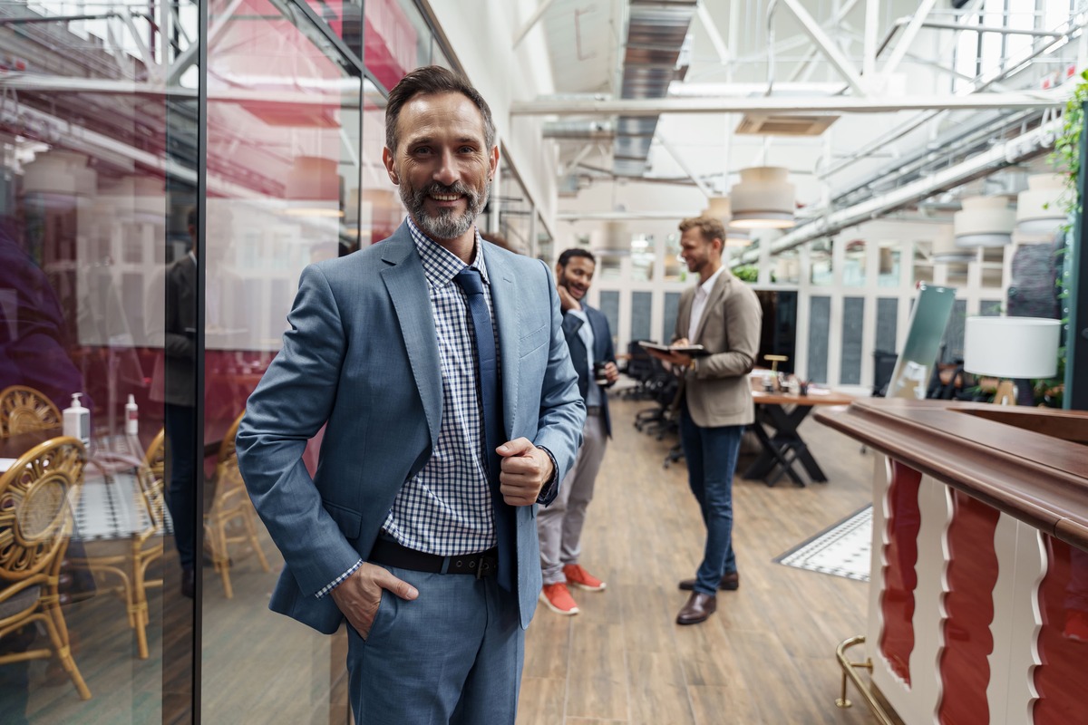 portrait-of-mature-businessman-standing-in-modern-2026-03-23-22-59-13-utc